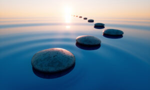 Stones in calm water with evening sun