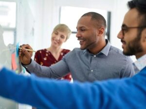 Multi-ethnic group hipster trendy business people during a positive brainstorm session for their small design agency